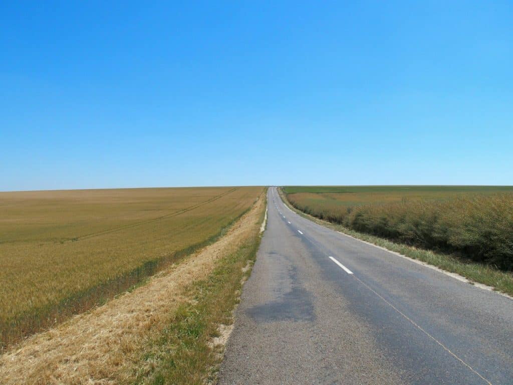 Country road along fields to the blue sky horizon (2014-07)