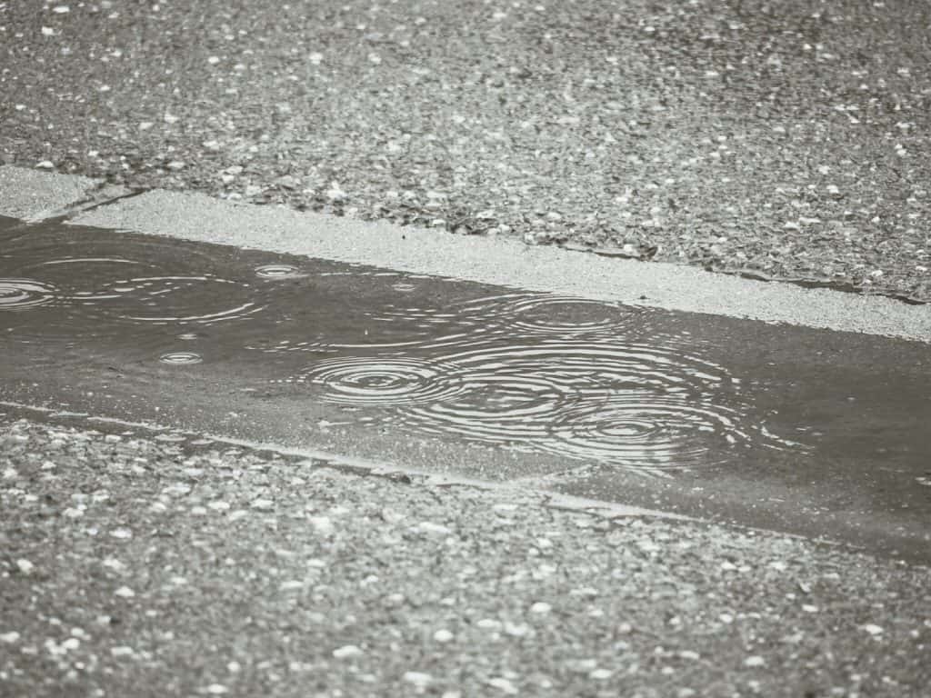 Rain falling on concrete road (2014-07)