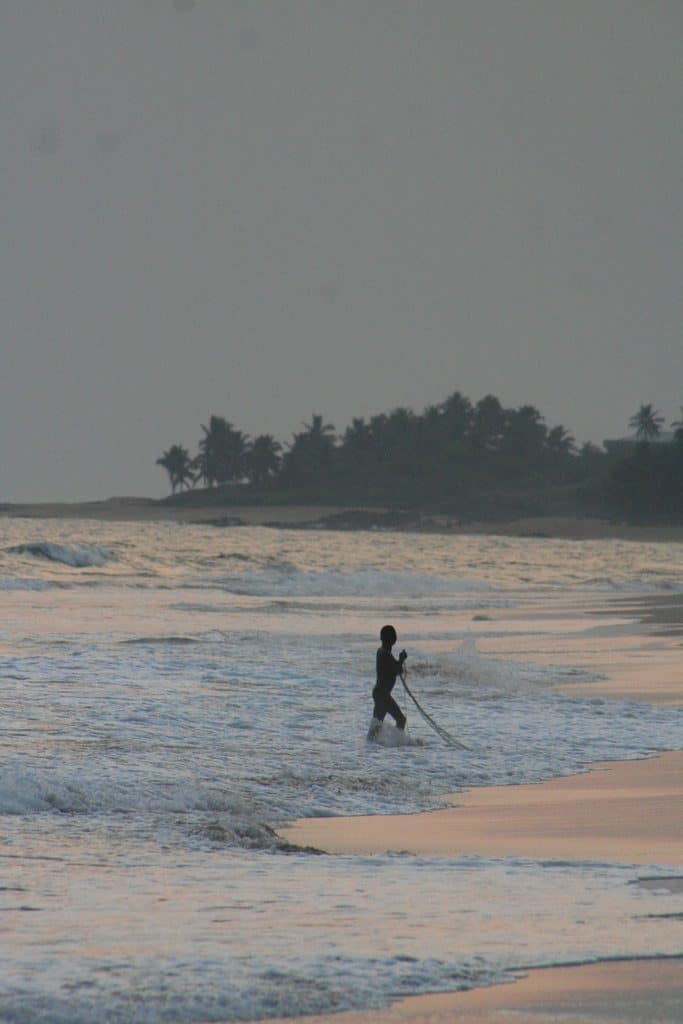 Fisherman in the water at sunset in Brenu Beach, Ghana (2011-12)