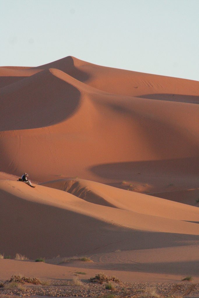 Couple in the sunset at Chebbi Erg dunes at the beginning of the Sahara desert, Morocco (2011-10)