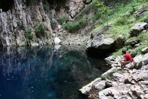 Man contemplating the water in Chinhoyi Caves National Park, Zimbabwe (2012-04)