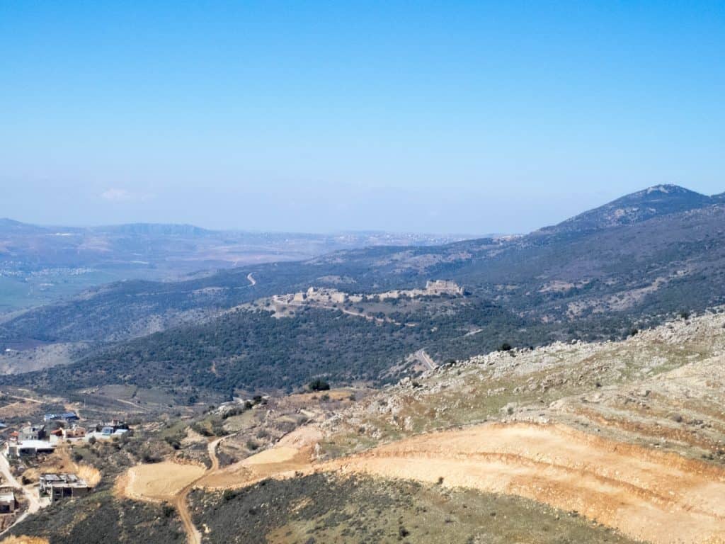 View towards Nimrod Fortress with Druze town Ein Kinya in the foreground, Golan Heights, Israel (2017-01-30)