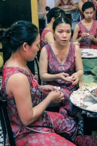 Ladies making White Rose on Hoi An food tour