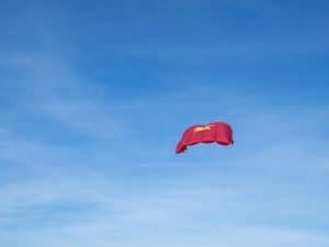 Travel Vietnam - Vietnamese flag kite at Hoi An beach, Vietnam (2017-05/06)