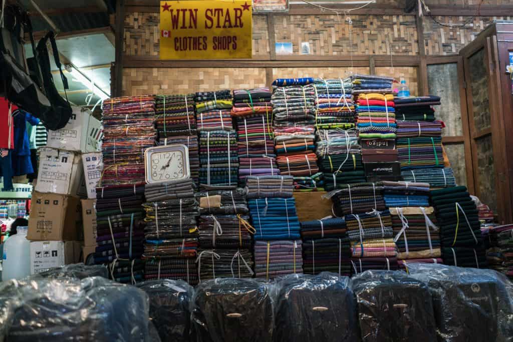 Clock and longyi at Nyaung-U market, Bagan, Myanmar (2017-09)