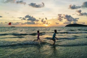 Kids playing at sunset on Pantai Cenang beach, Langkawi, Malaysia