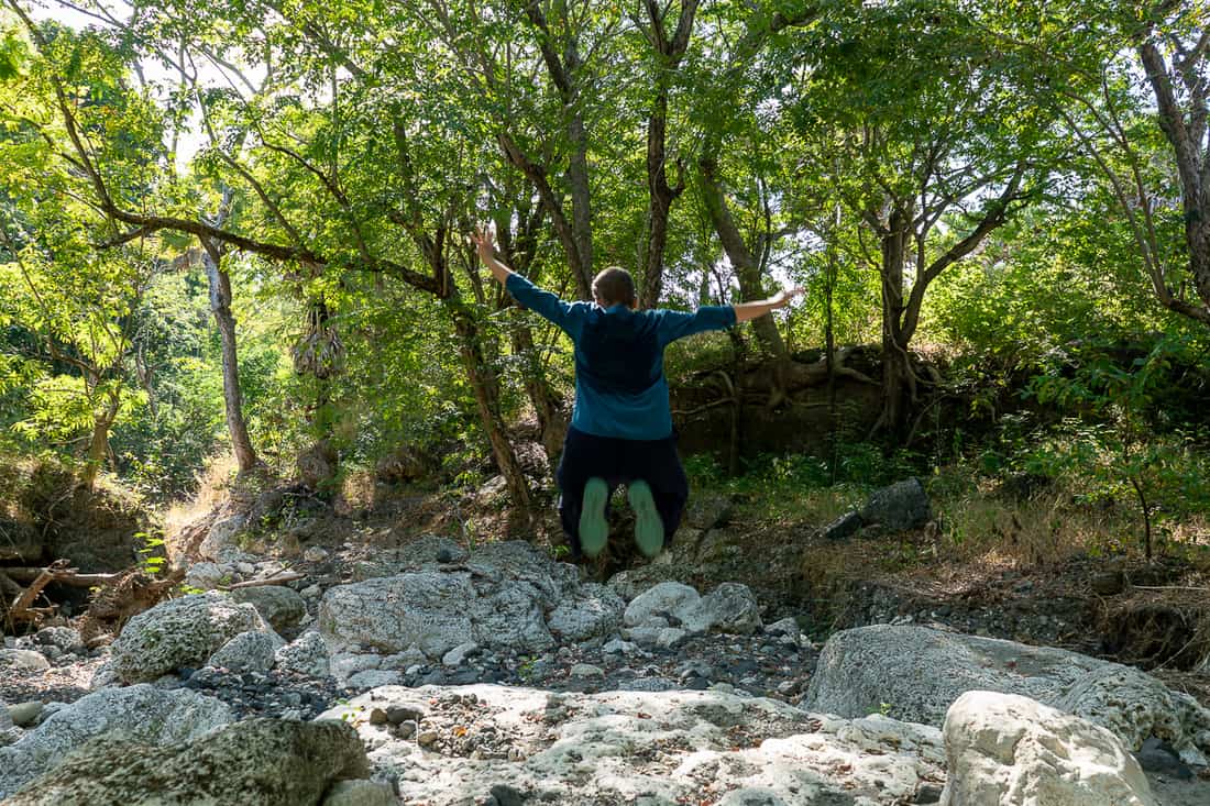 Carola jumps while hiking on Atauro, East Timor