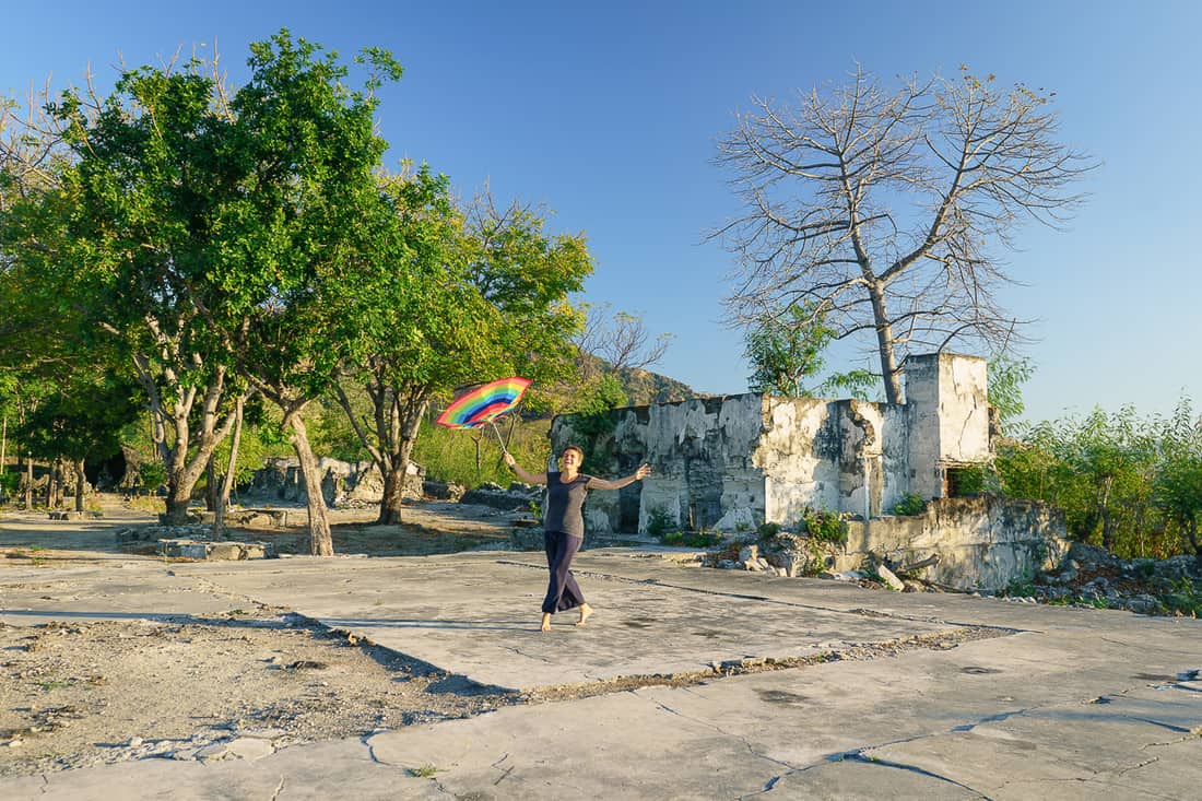 Carola with an umbrella at Faot Sub prison ruin, Pante Macassar, Oecusse, East Timor